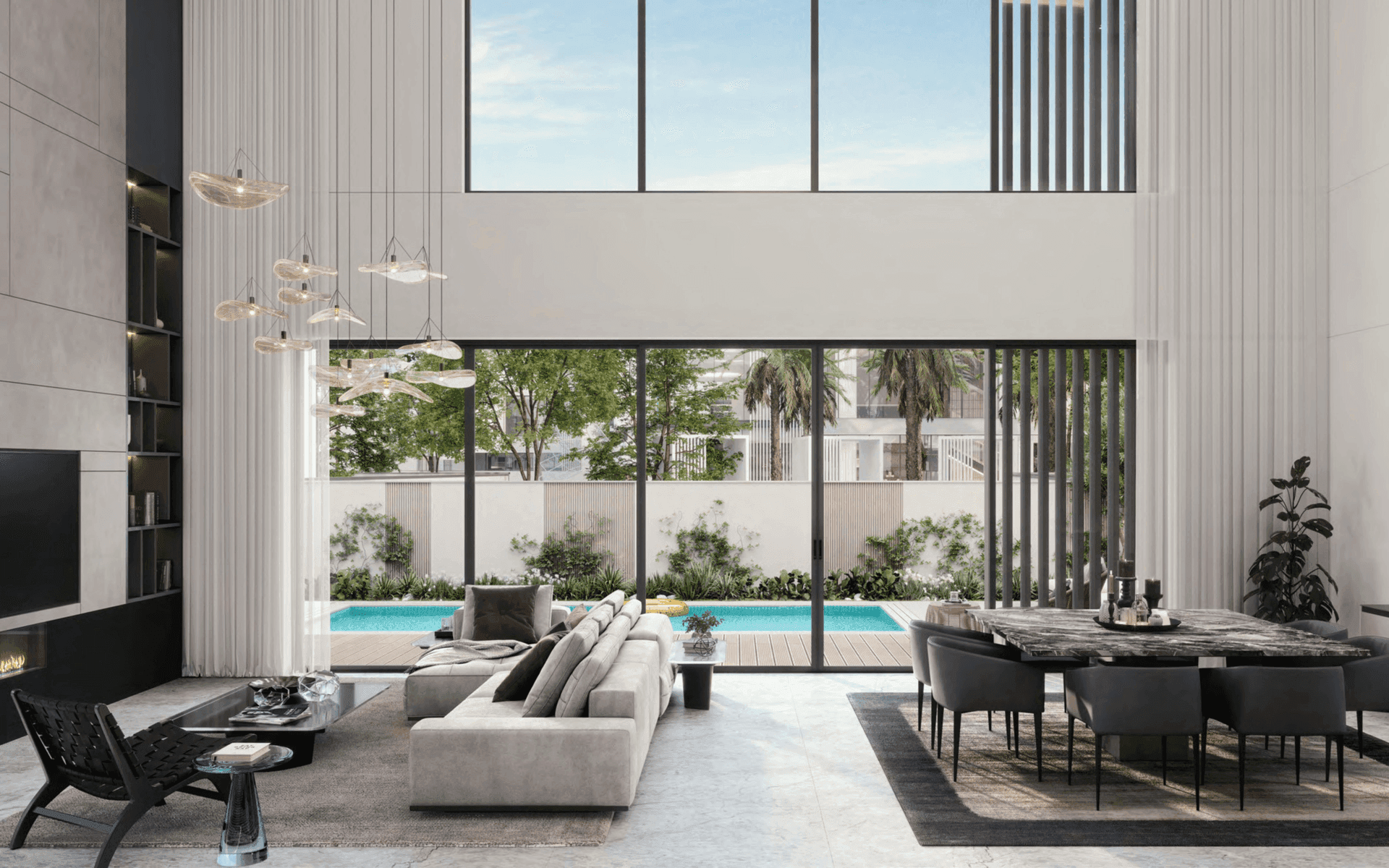 Double-height living room opening to a pool